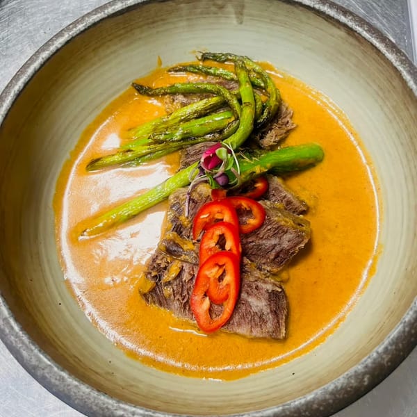 Lemongrass Asian Bistro's beef dish with asparagus, red peppers, and a rich orange sauce.