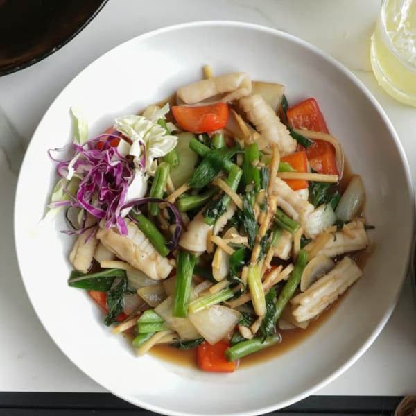 Lemongrass Asian Bistro's stir-fried squid with vegetables, including cabbage, tomatoes, and green onions.