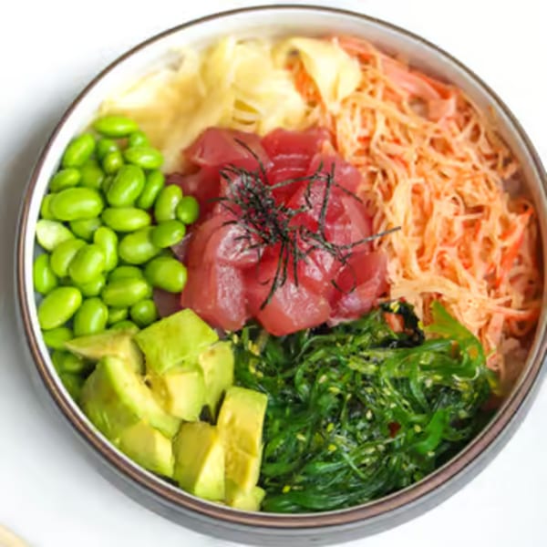 A colorful Lemongrass Asian Bistro sushi bowl with tuna, edamame, avocado, seaweed, and pickled ginger.